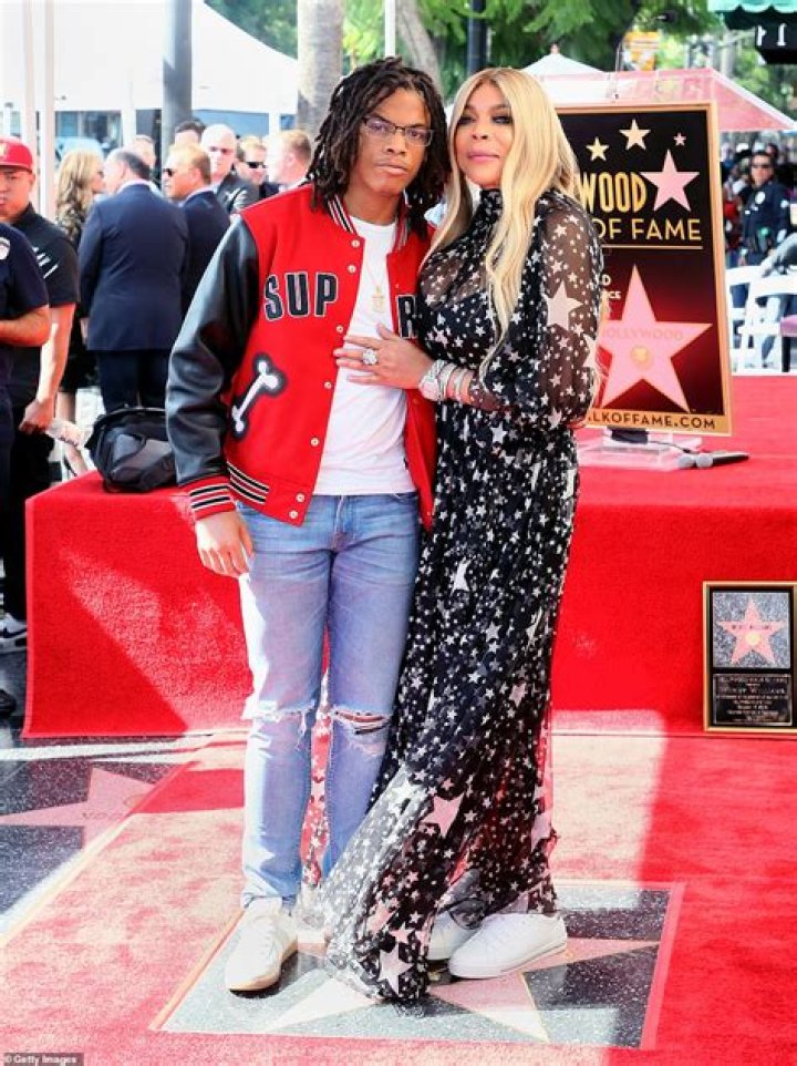 Wendy Williams, 58, holds onto the hand of handsome younger man and